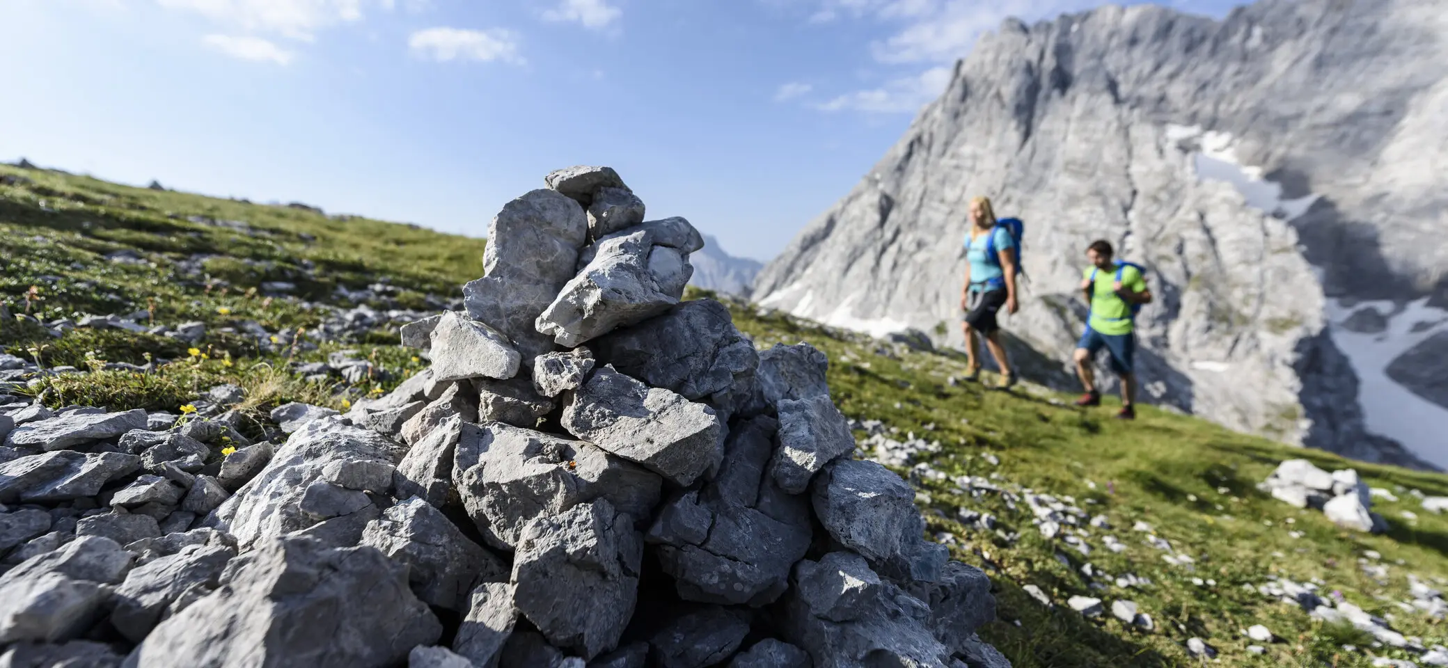 Beim Aufstieg: Wanderer in der Ferne, im Vordergrund eine Steinformation | © DAV/Wolfgang Ehn